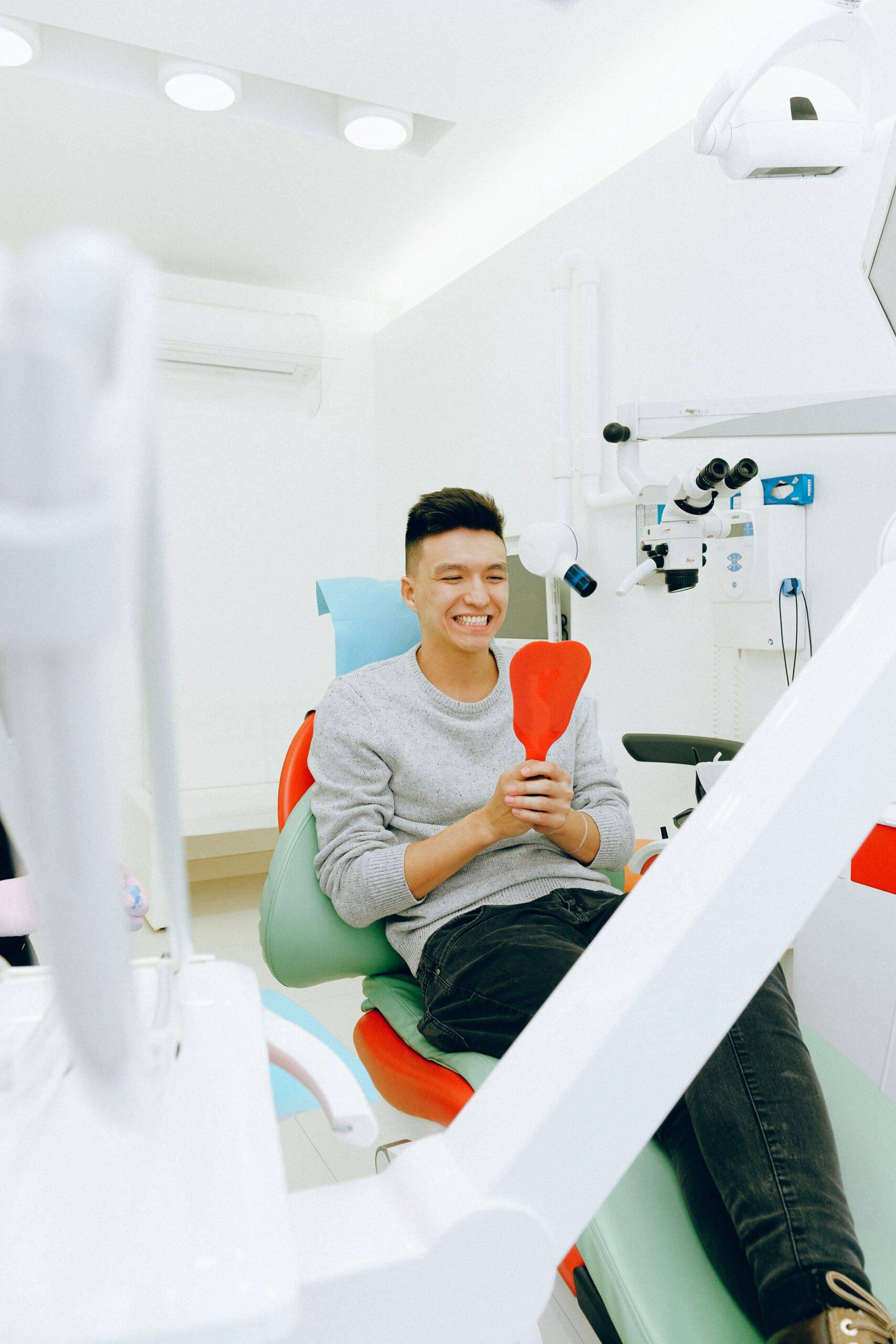 Man sitting on dentist chair smiling