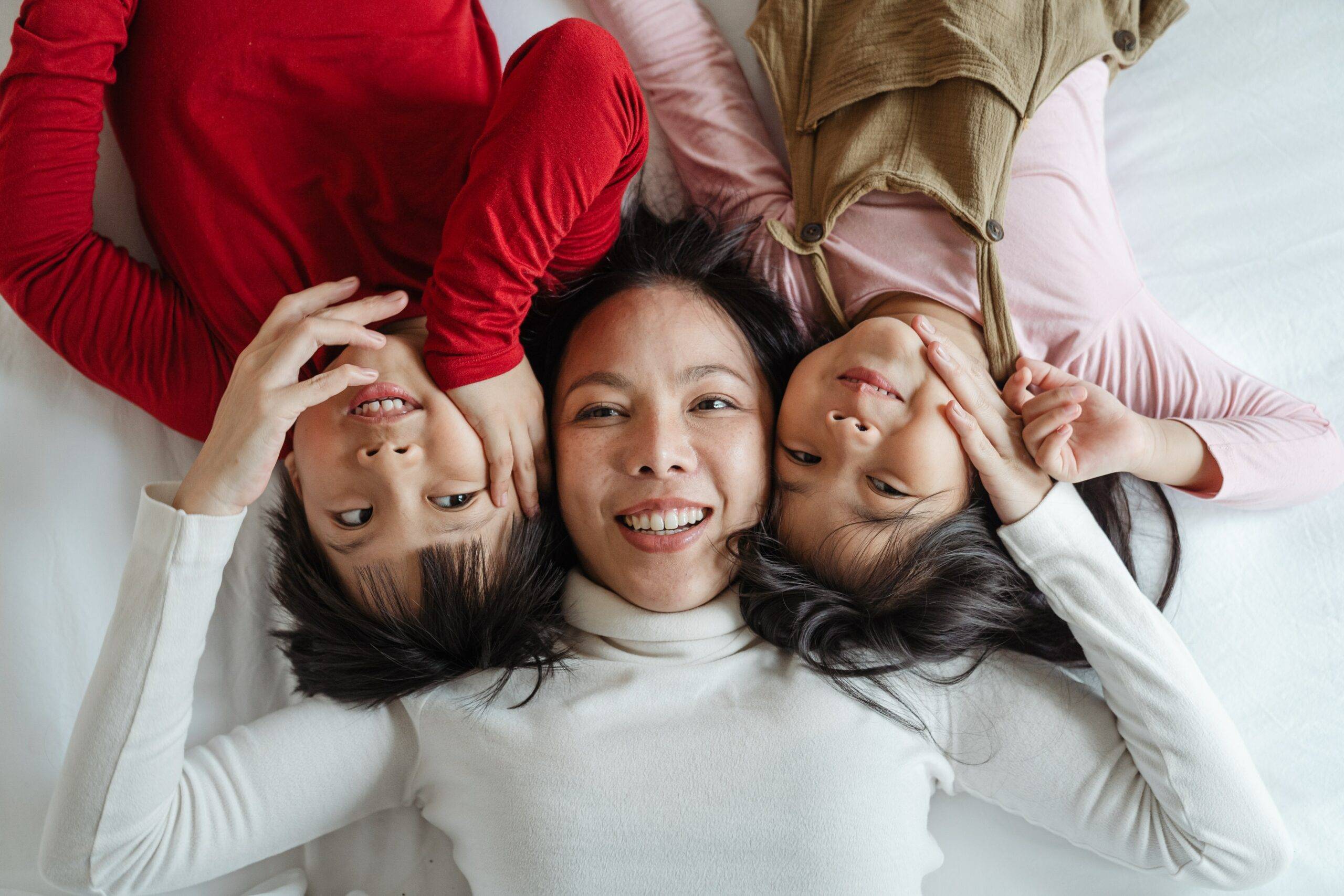 Photo of a woman and her children lying in bed