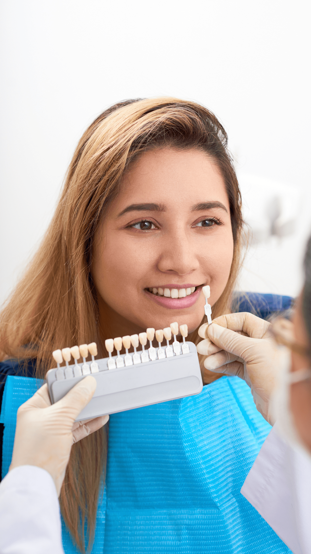 Dentist picking shade of veneers for patient